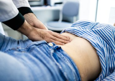 Abdominal examination by docot gastroenterologist at clinic.