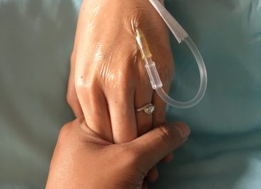 cropped-image-woman-holding-patient-hand-with-iv-drip-hospital